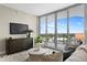 Comfortable living room featuring a large window with city view and stylish modern furnishings at 5120 Marina Way # 15006, Tampa, FL 33611