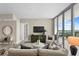 Open living room with floor-to-ceiling windows and a view of the city skyline at 5120 Marina Way # 15006, Tampa, FL 33611