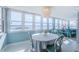 Bright dining area with large windows showcasing waterfront views and a modern light fixture at 5130 Brittany S Dr # 201, St Petersburg, FL 33715