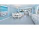 Open-concept dining area with chandelier lighting and a modern beach themed decor at 5130 Brittany S Dr # 201, St Petersburg, FL 33715