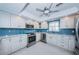 Contemporary kitchen with stainless appliances, white cabinets, and tile flooring at 5130 Brittany S Dr # 201, St Petersburg, FL 33715
