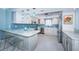 Elegant kitchen featuring stainless steel appliances, white cabinets, and a breakfast bar area at 5130 Brittany S Dr # 201, St Petersburg, FL 33715