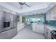 Open kitchen with stainless steel appliances, a breakfast bar, and seamless access to the living areas at 5130 Brittany S Dr # 201, St Petersburg, FL 33715