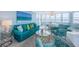 Bright living space featuring a sofa, chairs, and water views from several windows at 5130 Brittany S Dr # 201, St Petersburg, FL 33715