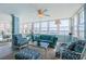 Bright living room featuring water views, comfortable seating, and a ceiling fan at 5130 Brittany S Dr # 201, St Petersburg, FL 33715