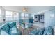 Bright living room featuring water views, comfortable seating, and access to the bedroom at 5130 Brittany S Dr # 201, St Petersburg, FL 33715