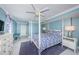 Bright bedroom features blue walls, a four-poster bed, and white furnishings at 5130 Brittany S Dr # 201, St Petersburg, FL 33715