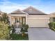 Charming single-Gathering home featuring a two-car garage and a welcoming front porch with rocking chairs at 5566 Silver Sun Dr, Apollo Beach, FL 33572