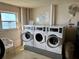Shared laundry room with modern washing machines and a view from the window at 5980 Shore S Blvd # 510, Gulfport, FL 33707