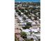 Aerial shot captures a neighborhood's layout, with rooftops and trees stretching to the distant ocean horizon at 9911 Antilles Dr, Seminole, FL 33776