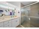 Updated bathroom featuring a marble countertop, a glass shower, and decorative accents at 9911 Antilles Dr, Seminole, FL 33776