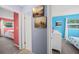 Hallway showcases access to bedrooms with unique wall decor and coordinating color schemes at 9911 Antilles Dr, Seminole, FL 33776