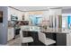 Updated kitchen with white cabinets, granite counters, and stainless appliances at 9911 Antilles Dr, Seminole, FL 33776