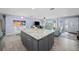 Open-concept living area with kitchen island and view of the living room at 9911 Antilles Dr, Seminole, FL 33776