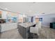 Stylish kitchen island with stainless steel appliances, and gray cabinets at 9911 Antilles Dr, Seminole, FL 33776