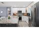 Modern kitchen with white cabinets, stainless steel appliances, and granite countertops at 9911 Antilles Dr, Seminole, FL 33776