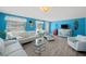 Bright living room features a unique VW bus entertainment center, tile flooring, and comfortable white furniture at 9911 Antilles Dr, Seminole, FL 33776