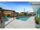Serene backyard with a sparkling pool, a covered pergola, and well-manicured landscaping, perfect for relaxation at 9911 Antilles Dr, Seminole, FL 33776