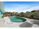Backyard pool with a covered pergola and lounge chairs amid lush landscaping, perfect for outdoor relaxation at 9911 Antilles Dr, Seminole, FL 33776