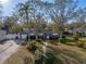 Aerial view of a charming single-story home with mature trees and an inviting walkway at 1213 60Th S St, Gulfport, FL 33707