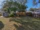 Large fenced backyard with lush lawn and storage shed, perfect for outdoor activities at 1213 60Th S St, Gulfport, FL 33707