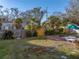 Fully fenced-in backyard with shade umbrella and outdoor dining area at 1213 60Th S St, Gulfport, FL 33707