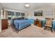 Bedroom featuring a large window, wainscoting, TV, and comfortable carpet at 1213 60Th S St, Gulfport, FL 33707