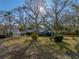 Charming single-story home with mature trees and manicured shrubs creating a welcoming curb appeal at 1213 60Th S St, Gulfport, FL 33707