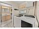 A tidy laundry room including side by side washer and dryer and small vanity at 1213 60Th S St, Gulfport, FL 33707