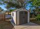 Backyard shed with double doors, a concrete path and a window under a blue sky at 1213 60Th S St, Gulfport, FL 33707