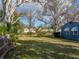 Well-maintained yard with mature trees, showcasing the home's curb appeal at 1213 60Th S St, Gulfport, FL 33707