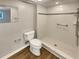 Updated bathroom featuring a walk-in shower with tile surround, modern fixtures and wood-look flooring at 1003 Hammock Pine Blvd # 1003, Clearwater, FL 33761