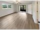 Bright bedroom featuring new floors, a ceiling fan, and sliding glass doors to the lanai at 1003 Hammock Pine Blvd # 1003, Clearwater, FL 33761