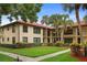 Beautiful condo featuring lush landscaping, a red tile roof, and exterior balconies at 1003 Hammock Pine Blvd # 1003, Clearwater, FL 33761