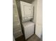 Convenient stacked washer and dryer unit with shelving for laundry supplies at 1003 Hammock Pine Blvd # 1003, Clearwater, FL 33761