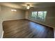 Spacious living room with hardwood floors and plenty of natural light from the windows at 1003 Hammock Pine Blvd # 1003, Clearwater, FL 33761
