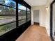 Bright sunroom featuring large windows and a doorway leading to another room at 1003 Hammock Pine Blvd # 1003, Clearwater, FL 33761