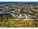 Panoramic aerial view of a residential community with homes interspersed with natural lakes and wooded areas at 10116 Deercliff Dr, Tampa, FL 33647