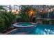 Beautiful pool and spa surrounded by lush landscaping, creating a private oasis at 10116 Deercliff Dr, Tampa, FL 33647