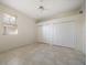 This bedroom features tiled floors, white trim, double closets, and a window at 109 Live Oak Ln, Largo, FL 33770