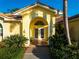 The front entrance welcomes you with double doors and arched transom window at 109 Live Oak Ln, Largo, FL 33770