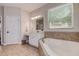 Bright bathroom featuring a soaking tub and vanity at 1221 Hillandale Reserve Dr, Tampa, FL 33613