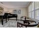 Elegant living room with a grand piano, plantation shutters, and sophisticated decor at 1221 Hillandale Reserve Dr, Tampa, FL 33613