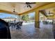 Expansive covered patio with dual ceiling fans, an outdoor kitchen area, and a view of the pool at 1221 Hillandale Reserve Dr, Tampa, FL 33613