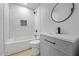 Bathroom featuring white subway tile, sleek black fixtures, and modern vanity at 1520 Arnold Ave, Brooksville, FL 34601