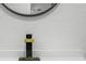 Close-up shot showcasing a modern black and gold faucet against a white countertop and textured wall at 1520 Arnold Ave, Brooksville, FL 34601