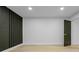 Bright bedroom with light wood floors, modern accent wall, recessed lights and a door to the side at 1520 Arnold Ave, Brooksville, FL 34601