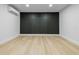 Minimalist room featuring light wood floors, a modern accent wall, and recessed lighting for a clean aesthetic at 1520 Arnold Ave, Brooksville, FL 34601