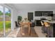 Bright dining area featuring a wooden table, six chairs, and sliding glass doors to the backyard at 1520 Arnold Ave, Brooksville, FL 34601