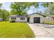 Charming one-story home with a well-maintained lawn, attached garage, and classic curb appeal at 1520 Arnold Ave, Brooksville, FL 34601